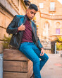 © unai - Trendy lifestyle of a Latino guy in the city. Jeans, leather jacket and brown shoes.