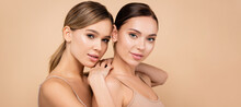 Young Woman With Perfect Skin Leaning On Shoulder Of Pretty Friend Isolated On Beige, Banner.