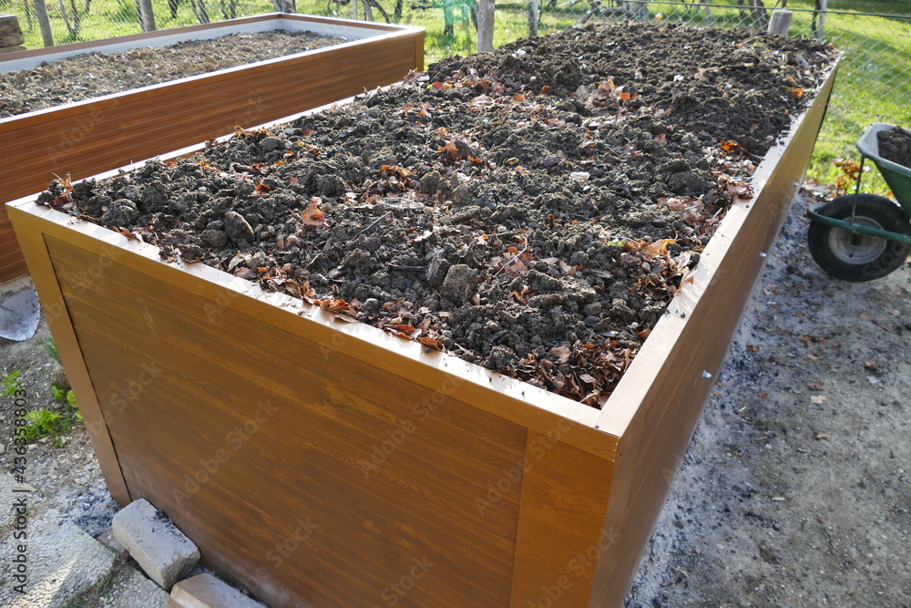 Building a raised-bed garden. A preparation stage where we are covering ...