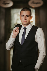 Poster - Vertical shot of a handsome Caucasian male with a suit