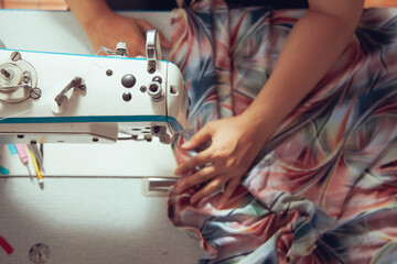 A seamstress quickly tailors the clothes. In order to deliver customers in time to see the top view