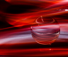 Sticker - Illustration of a round crystal ball with red smoke waves on black background