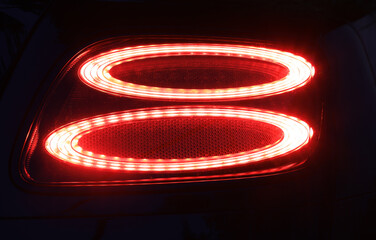 Wall Mural - car detail, red car rear lights at night