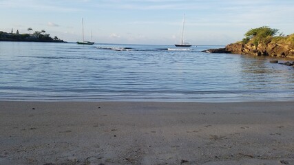 Caribbean view at sunrise with two sail boats