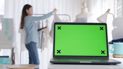 Notebook green screen on desk table home office designer studio workplace e-commerce startup sme with asia female worker work background supply chain logistic delivery template wifi network concept.