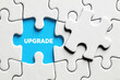 The word upgrade on a missing puzzle piece. To upgrade a software or hardware