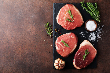 Wall Mural - Raw fresh beef meat on slate black plate. Top view flat lay with copy space