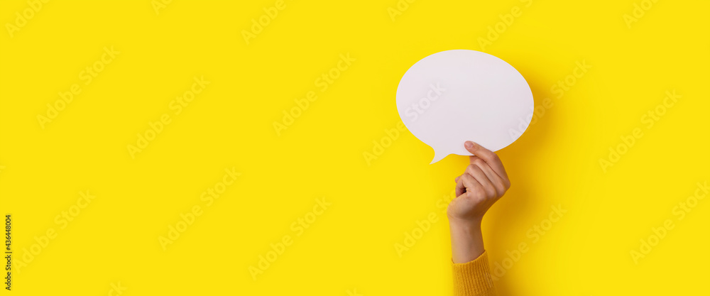 bubble speech layout in hand over yellow background, panoramic mock-up - obrazy, fototapety, plakaty 