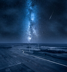 Wall Mural - milky way over wind turbines on field. alternative energy, poland.