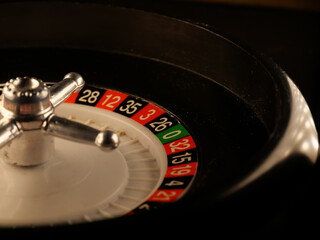 Sticker - Closeup shot of a luxury casino roulette wheel on a black background