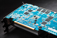 A Blue Board With Chips And A Gaming Graphics Card Processor.