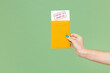 © ViDi Studio - Close up cropped woman hold in hand passport covid-19 immune vaccination boarding pass ticket isolated on green color background Passenger travel abroad on weekends getaway Air flight journey concept