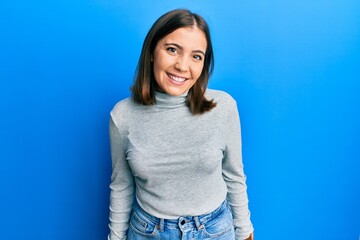 Poster - Young beautiful woman wearing casual turtleneck sweater looking positive and happy standing and smiling with a confident smile showing teeth