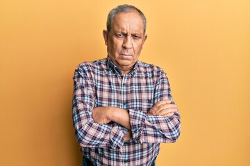 Sticker - Handsome senior man with grey hair wearing casual shirt skeptic and nervous, disapproving expression on face with crossed arms. negative person.