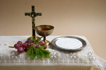 Canvas Print - The Feast of Corpus Christi Concept. Holy communion and cup of glass with red wine on table.