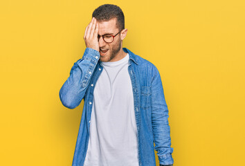 Wall Mural - Young caucasian man wearing casual clothes yawning tired covering half face, eye and mouth with hand. face hurts in pain.