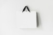 White paper shopping bag on white background with copy space