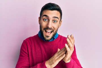 Young hispanic man wearing casual clothes clapping and applauding happy and joyful, smiling proud hands together