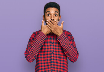 Canvas Print - Young african american man wearing casual clothes shocked covering mouth with hands for mistake. secret concept.