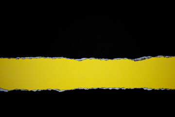 Wall Mural - torn black paper Placed on a yellow background Picture for text Background and copy space