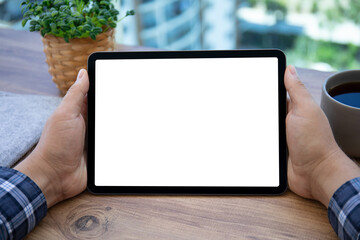 male hands holding computer tablet with isolated screen in cafe