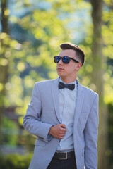 Wall Mural - Vertical shot of a white Caucasian man wearing a classic blue suit and posing for a picture