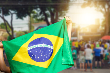 Man holding flag at street demonstration against corruption in Brazil. Concept democracy image with space text.