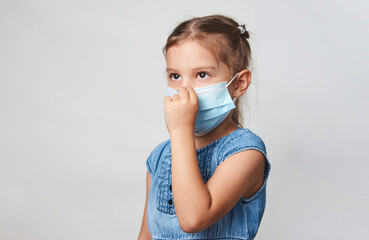 Wall Mural - Little girl wearing face mask on a white background