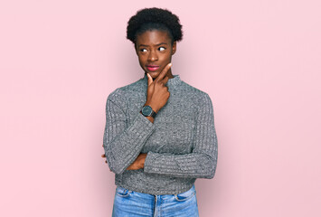 Sticker - Young african american girl wearing casual clothes with hand on chin thinking about question, pensive expression. smiling with thoughtful face. doubt concept.