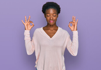 Sticker - Young african american girl wearing casual clothes relaxed and smiling with eyes closed doing meditation gesture with fingers. yoga concept.