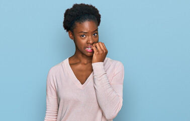 Sticker - Young african american girl wearing casual clothes looking stressed and nervous with hands on mouth biting nails. anxiety problem.