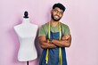 © Krakenimages.com - Arab man with beard dressmaker designer wearing atelier apron happy face smiling with crossed arms looking at the camera. positive person.