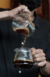 The drip coffee flows into another jug.