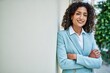 © Krakenimages.com - Young hispanic business woman wearing professional look smiling confident at the city leaning on the wall