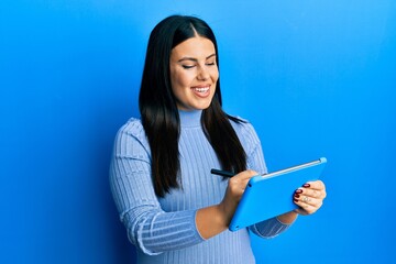 Sticker - Beautiful brunette woman using touchpad drawing on screen smiling with a happy and cool smile on face. showing teeth.