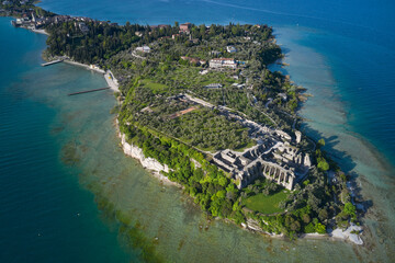 Wall Mural - Aerial view of the Grotte di Catullo Ruins at high altitude. Grottoes ruins on the Sirmione peninsula. Olive grove and archaeological museum. Lake Garda, Italy.