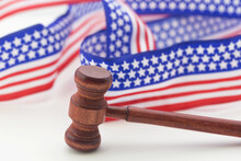 Gavel With Stars And Stripes Ribbon On White Background Reflect American Justice System And Democracy
