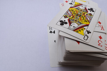 Sticker - Closeup shot of the queen of clovers at the top of a playing cards stack with a copy space