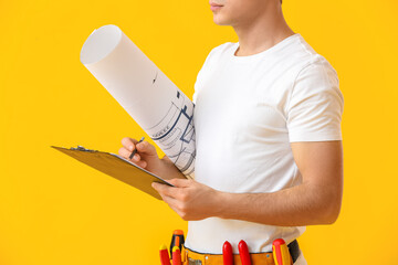 Poster - Young electrician writing in clipboard on color background