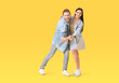 © Pixel-Shot - Happy young couple dancing on color background