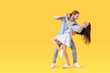 © Pixel-Shot - Happy young couple dancing on color background