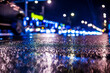 © Georgii Shipin - Rainy night in the big city, dense traffic at a busy intersection in the light of shop windows. View from the level of asphalt