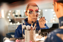 Drag Queen Looking At The Mirror And Applying Blushes At His Face