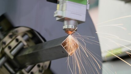 Canvas Print - Laser cutting of metal pipe with sparks on tube laser machine