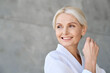 © insta_photos - Headshot of happy smiling gorgeous middle aged woman wearing bathrobe at spa salon hotel looking away. Advertising of bodycare spa procedures antiage dry skin care products concept.
