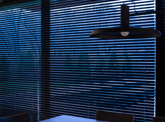 Leinwandbilder - Wood blinds black color on large windows in the interior. The park is visible through the blinds. Motorized venetian wooden blinds closeup. Selective focus. 