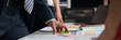 © megaflopp - Business people studying charts and documents at table in office
