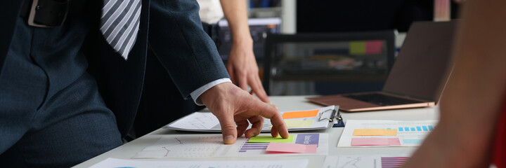 Wall Mural - Business people studying charts and documents at table in office