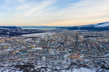 Wall Mural - Aerial view of the city of Magadan. Northern city on the coast of the Sea of ​​Okhotsk. Winter city landscape. Top view of the streets and buildings. Magadan, Magadan region, Siberia, Far East Russia.