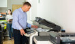 © JackF - Confident businessman using printer in office. High quality photo
